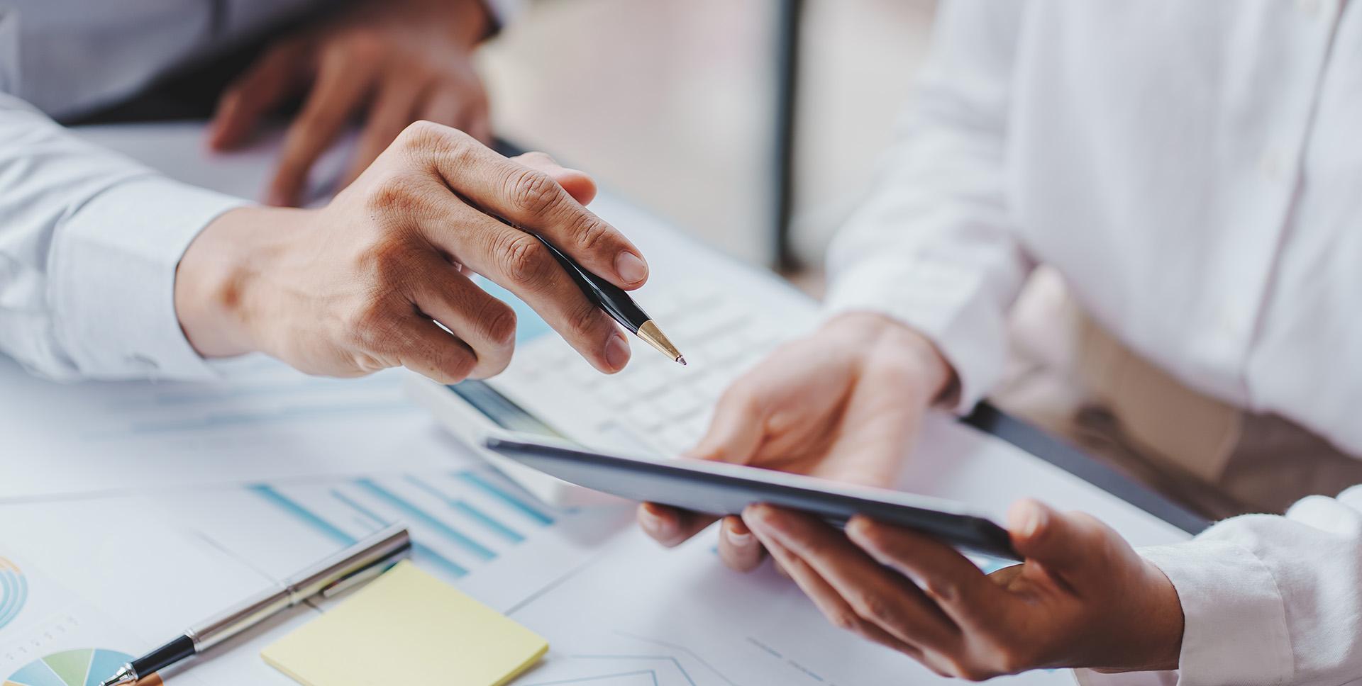 Close up of pharamacists looking at business plans on a tablet